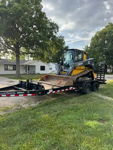 John Deere compact track loader staged on a trailer for a Foil Land Services job